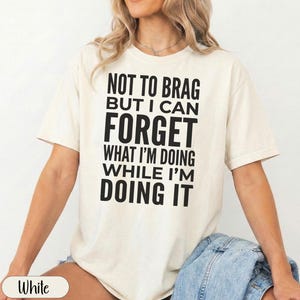 Cream t-shirt with "Forget What I'm Doing While I'm Doing It" text.