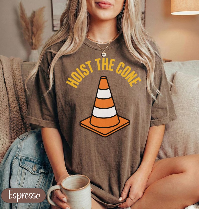 Brown t-shirt with "Hoist the Cone" text and a traffic cone graphic.