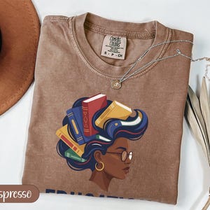Brown t-shirt with graphic of woman with books in her hair, size SP-CH.