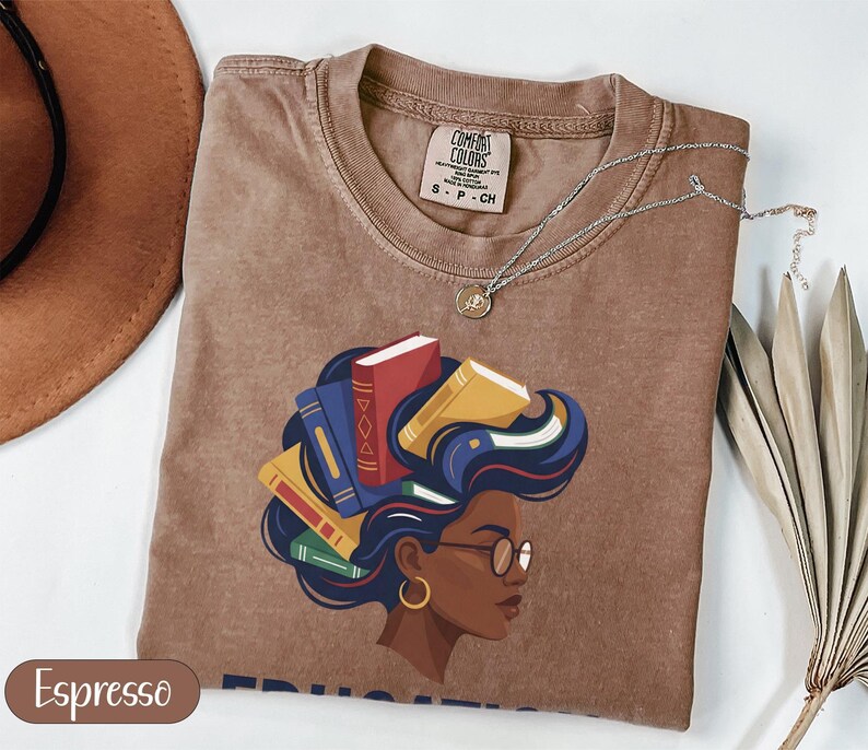 Brown t-shirt with graphic of woman with books in her hair, size SP-CH.