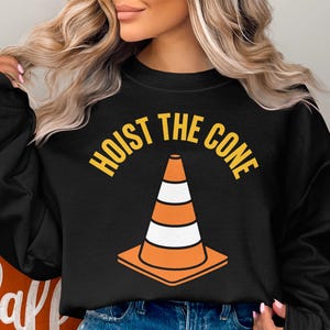 Black sweatshirt with orange and white traffic cone and "Hoist the Cone" text.