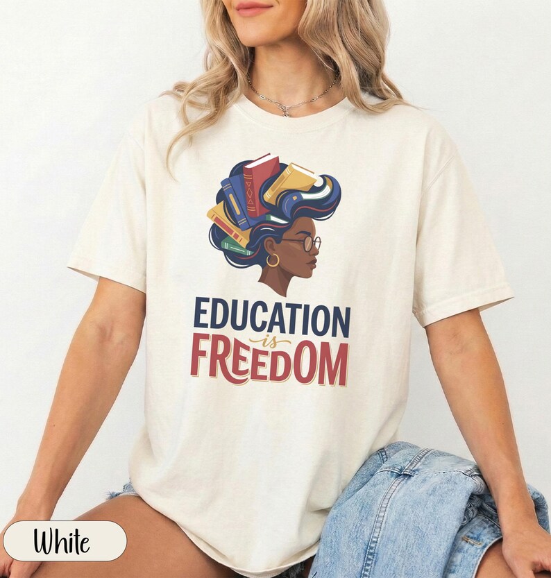 Woman with books in her hair wearing "EDUCATION IS FREEDOM" t-shirt.