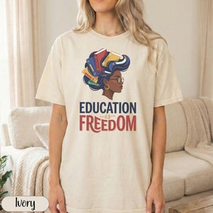 T-shirt with "EDUCATION IS FREEDOM" text and woman with books in her hair.
