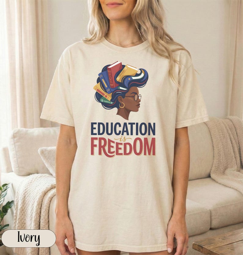 T-shirt with "EDUCATION IS FREEDOM" text and woman with books in her hair.