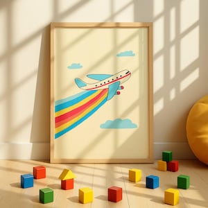 May include: A framed print featuring a cartoon airplane with blue wings and a red tail, trailing a rainbow. The artwork is set against a light yellow background with blue clouds. Colorful wooden blocks are scattered on the wooden floor.