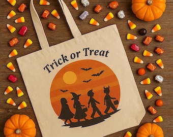 May include: Beige canvas tote bag with the words "Trick or Treat" printed on it. The bag features a Halloween-themed graphic of children trick-or-treating under a sunset. Candy corn, wrapped sweets, and pumpkins are scattered around the bag.
