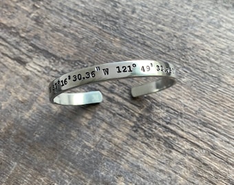 May include: A silver bracelet with the coordinates "37°16' 30.36" W 121° 49' 33.95" engraved on it.