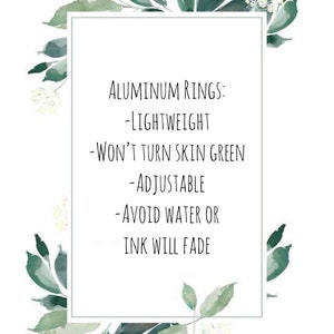 May include: Aluminum rings with a white background and green floral accents. The text reads: "Aluminum Rings: -Lightweight -Won't Turn Skin Green -Adjustable -Avoid Water or Ink Will Fade"