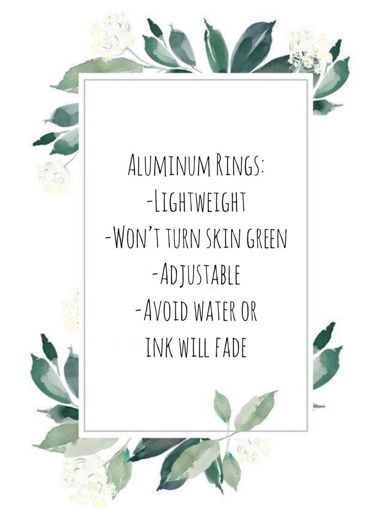 May include: Aluminum rings with a white background and green floral accents. The text reads: "Aluminum Rings: -Lightweight -Won't Turn Skin Green -Adjustable -Avoid Water or Ink Will Fade"