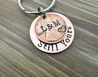 May include: A copper penny keychain with the words "Still Yours" engraved on the back. The front of the penny has the words "In God We Trust" and "Liberty" engraved, along with the initials "L&M" and the year "1978".