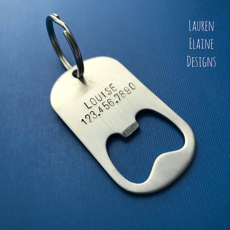 May include: Silver bottle opener keychain with a ring and the text "LOUISE 123.456.7890" engraved on it.