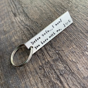 May include: Silver keychain with a rectangular tag that reads "Drive safe... I need you here with me.  <3".