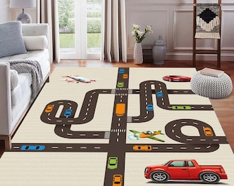 May include: A beige rug with a road design featuring brown roads, colorful toy cars, and an airplane. The rug has a playful design, perfect for a child's bedroom or playroom. The rug is rectangular and has a soft texture.
