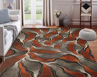 May include: A rectangular area rug with a flowing, abstract design in shades of brown, orange, and gray. The pattern features wavy lines and organic shapes, creating a modern and artistic look. This rug is suitable for living rooms and bedrooms.