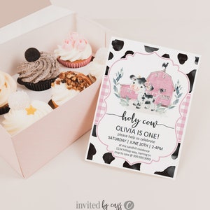 May include: A pink and white cow-themed party invitation with a watercolour illustration of a cow and a red barn. The text reads "holy cow Olivia is one! please help us celebrate Saturday | June 20th | 2-4pm at the sandhill residence 1234 hilltop way, herring tn rsvp to cass @ 999.999.9999 invited by cass".