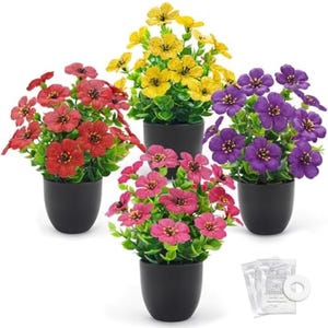 May include: Four potted artificial flower arrangements in red, yellow, pink, and purple. Each arrangement features vibrant blooms and green foliage in a black pot. A small packet of plant food and a white ring are in the bottom right corner.