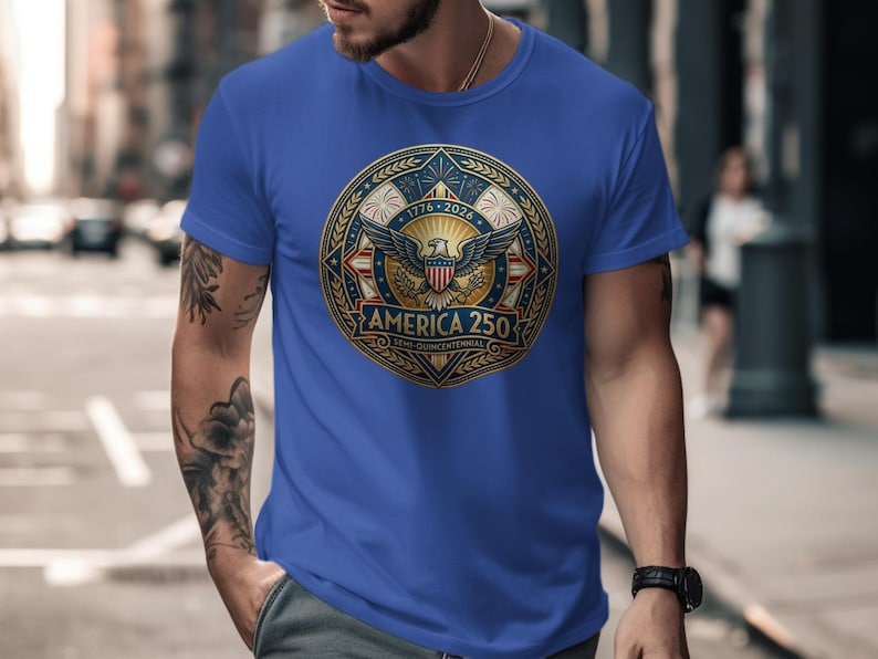 Blue t-shirt with round "America 250" logo featuring eagle and fireworks.