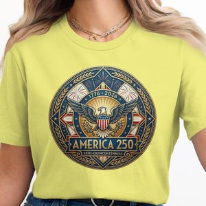 Yellow t-shirt with America 250 Semi-Quincentennial circular emblem featuring an eagle.