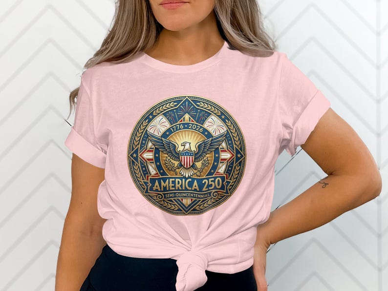 Pink t-shirt with "America 250" emblem celebrating 1776-2026.