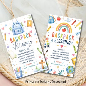 Puede incluir: Dos etiquetas rectangulares de papel con lazos de cuerda que presentan ilustraciones en acuarela de material escolar, un arcoíris, una cruz y una mochila. El texto dice Backpack Blessing, Dear Lord y Amen.