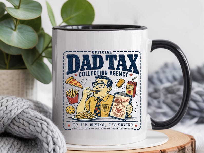 May include: White ceramic mug with a black interior and handle. The mug features a graphic of a man eating fries, with the text "OFFICIAL DAD TAX COLLECTION AGENCY" and "IF I'M BUYING, I'M TRYING".
