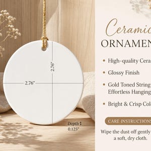 Puede incluir: Un adorno redondo de cer&aacute;mica blanca con acabado brillante y cord&oacute;n dorado. El adorno mide 7,01 cm de di&aacute;metro y 0,32 cm de profundidad. El texto en la imagen incluye Ceramic Ornament, High-quality Ceramic, Glossy Finish, Gold Toned String for Effortless Hanging, Bright & Crisp Colors y Care Instructions: Wipe the dust off gently with a soft, dry cloth.