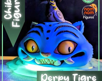 May include: A blue chibi figure of a tiger with large yellow eyes and a toothy grin. A small bird wearing a hat sits on top. The figure is labeled "Derpy Tigre" and "Chibi Figure". The figure is part of the "nom nom Figures" collection.