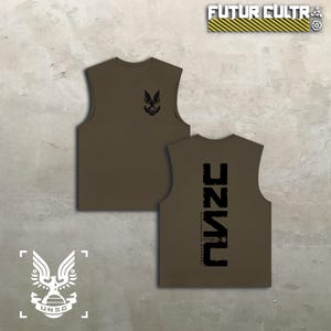 May include: An olive green sleeveless shirt featuring a black UNSC eagle emblem on the front chest. The back of the shirt displays large, vertically oriented black text reading UNSC with smaller text below it. The top right corner shows FUTUR CULTR.