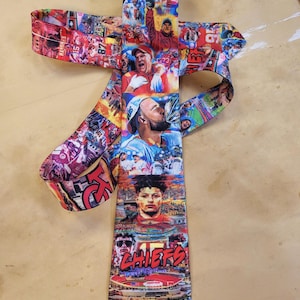 May include: A colorful necktie featuring a collage of images and the text "CHIEFS". The tie has a vibrant design with images of football players and the team's logo. The tie is a unique accessory for fans.
