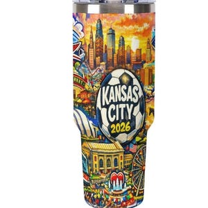 May include: A stainless steel travel tumbler featuring a colorful illustration of Kansas City landmarks and a soccer ball design. The text "Kansas City 2026" is prominently displayed on the tumbler, which is designed to keep beverages hot or cold.