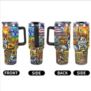 May include: A set of four stainless steel travel mugs with black handles. Each mug features a colorful design showcasing Kansas City landmarks, including the skyline, stadiums, and the text "Kansas City 2026". The mugs have a black handle and a silver lid.