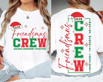 May include: A white t-shirt featuring a red and green graphic print. The front displays the text "Friendsmas CREW" with "2026" under a Santa hat. The back shows the same text vertically with "MAKING MEMORIES TOGETHER" in green.