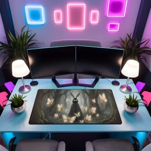 May include: A gaming setup featuring two black computer monitors, a mousepad with a forest and butterfly design, and a light blue desk. The desk is illuminated by neon lights and small lamps. Potted plants and chairs complete the scene.