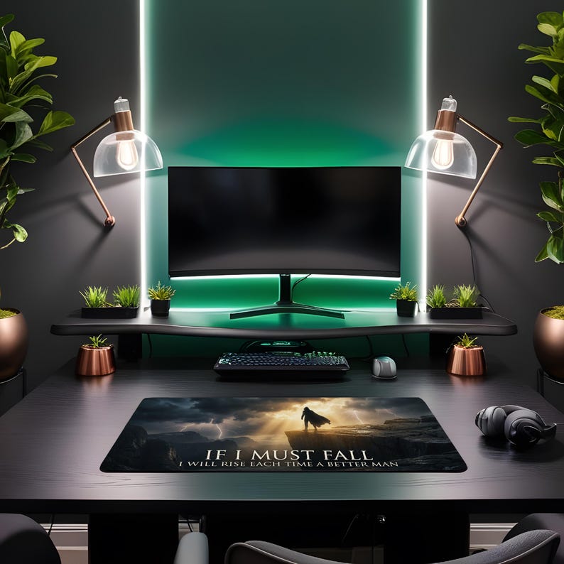 May include: A modern gaming setup featuring a curved monitor, keyboard, and mouse. A mousepad displays the text "IF I MUST FALL I WILL RISE EACH TIME A BETTER MAN". The desk is black, with copper-toned accents and green ambient lighting.
