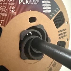 Könnte beinhalten: Eine Spule schwarzes Overture PLA 3D-Druckerfilament. Die Pappspule zeigt Informationen wie Düsentemperatur (190-220°C), Betttemperatur (25-60°C) und eine Filamentlänge von 330m. Das Filament ist für den täglichen Gebrauch konzipiert.