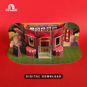 May include: A papercraft tea shop with a red and brown facade, awnings, and a sign that reads "TEA SHOP." The shop features a menu board and a "GREEN TEA" sign. The words "DIGITAL DOWNLOAD" are at the bottom.