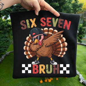 May include: Black square pillow with a cartoon turkey wearing sunglasses and a backward cap, dabbing. The text "SIX SEVEN BRUH" is printed above and below the turkey in colorful letters. The turkey is wearing sneakers.