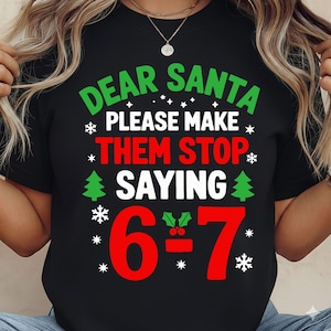 May include: Black t-shirt with a Christmas-themed graphic. The text reads "DEAR SANTA PLEASE MAKE THEM STOP SAYING 6÷7" in green and red, with snowflakes and Christmas trees. A festive holiday design.