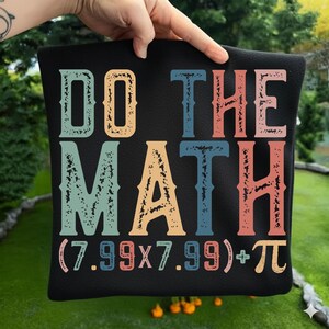 May include: Black pillow with the words "DO THE MATH" in colorful, distressed lettering. The pillow also features a math equation: (7.99x7.99)+π. The text is in orange, blue, teal, and coral.