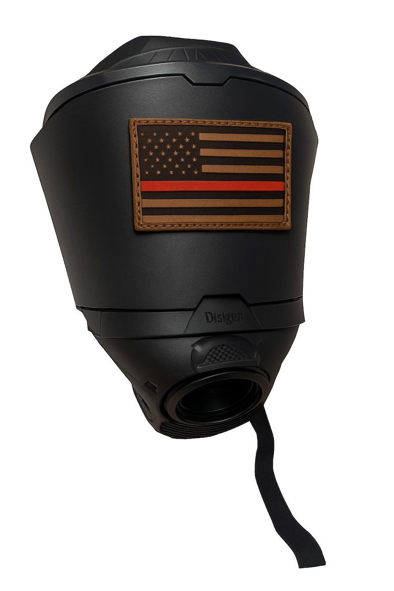 May include: A matte black tactical-style cover featuring a rectangular brown leather patch with a debossed American flag design and a horizontal red stripe. The word Disigen is embossed on the lower section, which includes a circular opening and a strap.
