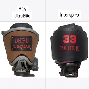 May include: Two firefighter mask covers. The left is tan leather with a black patch reading DHFD T. MORGAN, labeled MSA Ultra Elite. The right is black leather with red text reading 33 FAULK, labeled Interspiro. Both feature custom lettering.
