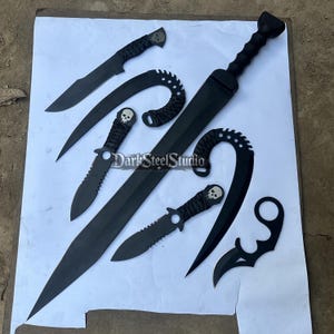 May include: An assortment of black metal blades, including a long sword, curved knives, and daggers, are arranged on a white surface. Some blades feature skull designs on the handles. The text "DarkSteelStudio" is visible.