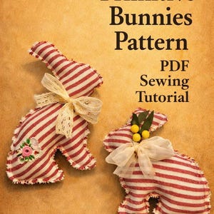 May include: Two handmade, red and white striped fabric bunny decorations with cream-coloured bows. One bunny has a floral patch. The image also includes the text "Primitive Bunnies Pattern PDF Sewing Tutorial."