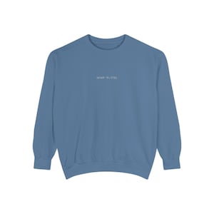 May include: A solid blue sweatshirt with the text "sean along" in small, white lettering centered on the chest. The long-sleeved top is made of a soft material and is suitable for casual wear.