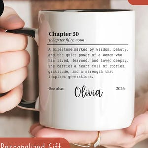 May include: White ceramic mug with black handle and rim, featuring the text "Chapter 50" and a definition. The mug includes the name "Olivia" and the year "2026". A personalized gift.