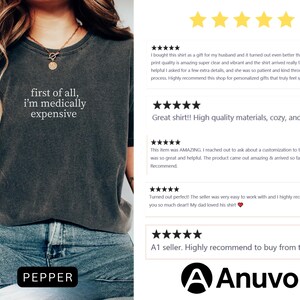 May include: Dark gray t-shirt with the text "first of all, I'm medically expensive" in white. The shirt is worn by a person. The word "PEPPER" is in a black rectangle at the bottom of the image. Reviews are shown on the right.
