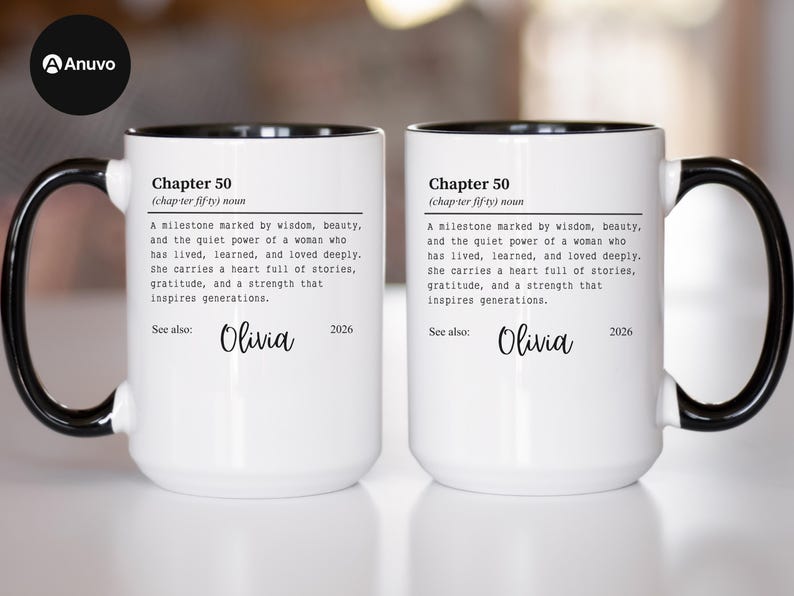 May include: Two white ceramic mugs with black handles and rims. Each mug features the text "Chapter 50" and a definition, along with the name "Olivia" and the year "2026". The mugs are designed for gifting.