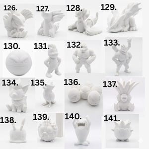 May include: A collection of sixteen white 3D printed figures labeled 126 through 141, featuring various creature designs. Each figure is matte white, displaying distinct shapes including spherical, humanoid, and animal-like forms on a plain background.
