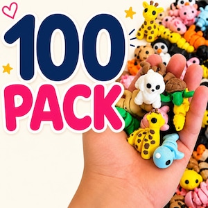 May include: A collection of 100 small, colorful animal-shaped resin charms in a variety of designs including giraffes, turtles, and penguins. The text 100 PACK is displayed in large blue and pink letters next to the assortment of miniature figures.