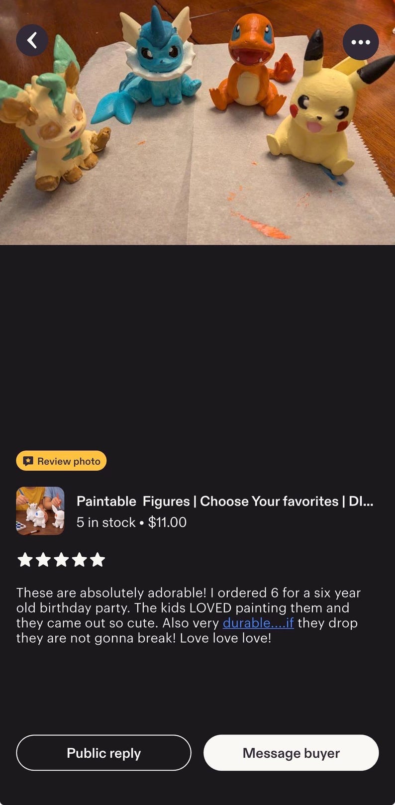 May include: Four small, hand-painted character figures arranged on a white surface. The figures include a light green and tan creature, a blue aquatic creature, an orange fire-breathing creature, and a yellow creature with black-tipped ears.
